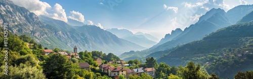 A stunning view of a village nestled in the scenic mountains  with houses  roads  and trees dotting the landscape. The mountains loom majestically in the background  creating a picturesque setting.