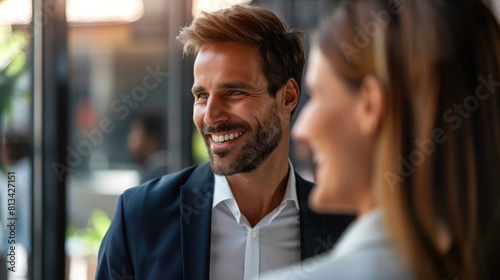 Smiling businessman looking at businesswoman during networking seminar