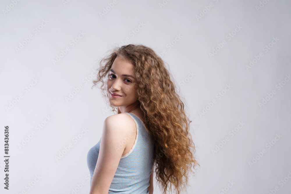 Portrait of a gorgeous teenage girl with curly hair. Studio shot, white background with copy space Portrait of a gorgeous teenage girl with curly hair. Studio shot, white background with copy space