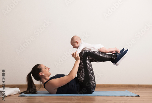 Home exercise for mother and baby, mommy and me workout. Physical activity for mother while bonding with children. photo