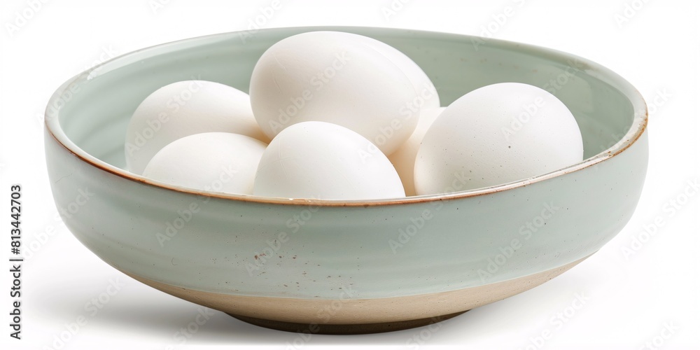 White bowl filled with isolated chicken eggs. White bowl filled with isolated chicken eggs.