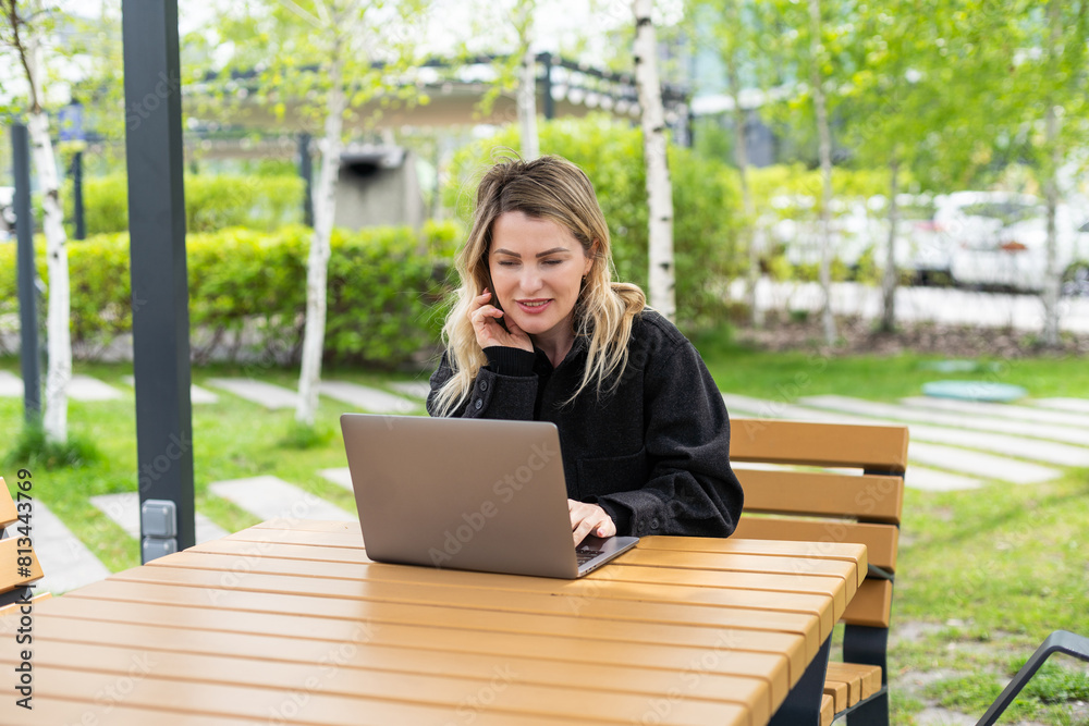 Young woman with laptop outside Young woman with laptop outside