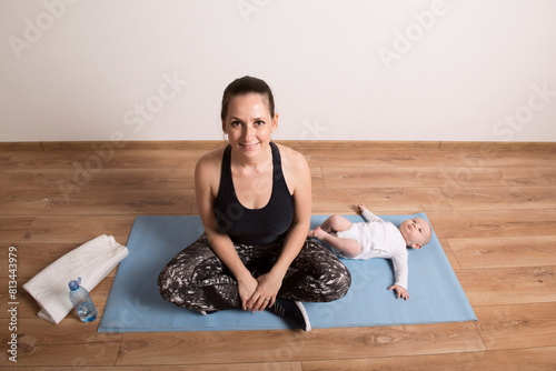 Home exercise for mother and baby, mommy and me workout. Physical activity for mother while bonding with children. photo