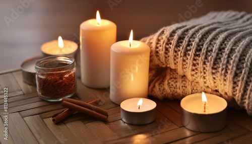 Warm and Cozy: Home Composition with Candles, Aroma Sticks, and Knitted Element"