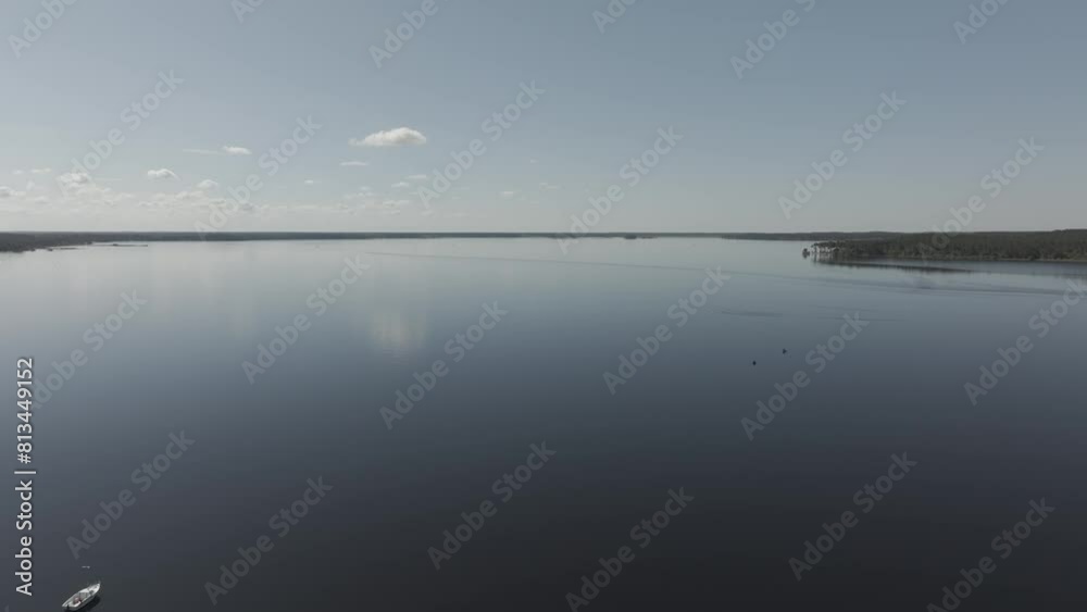 Calm water surface of Lake Lacanau west of Bordeaux France, Aerial flyover shot Calm water surface of Lake Lacanau west of Bordeaux France, Aerial flyover shot