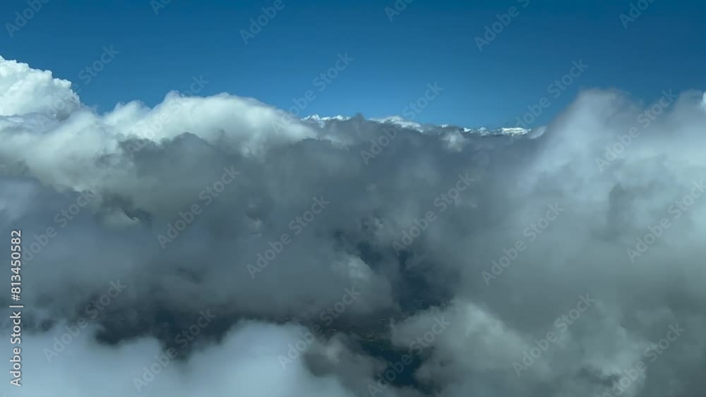 Pilot POV flying across some fluffy white and grey clouds. Immersive view from the cockpit. Daylight. 4K 60FPS Pilot POV flying across some fluffy white and grey clouds. Immersive view from the cockpit. Daylight. 4K 60FPS