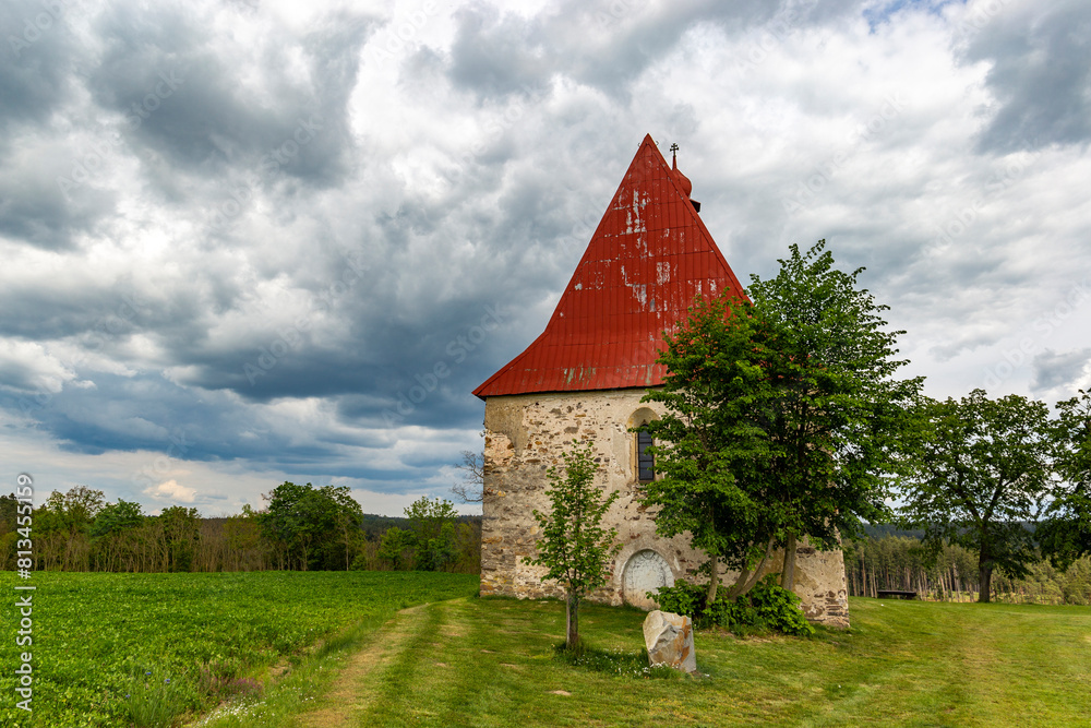 Fototapeta premium Old church in the summer field. Dobronice u Bechyne, Czech republic.