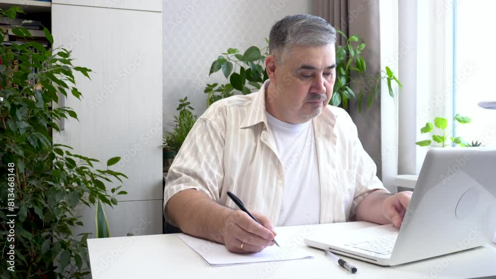 A man is engaged in distance learning at home, communicating via video call. Ideal for content about online education, freelancing and remote work.