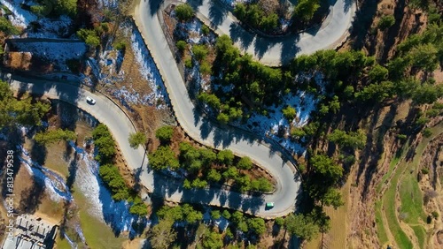 Top shot of curvy roads of Malam Jabba Swat Valley in Pakistan during sunny day. Drone view. photo