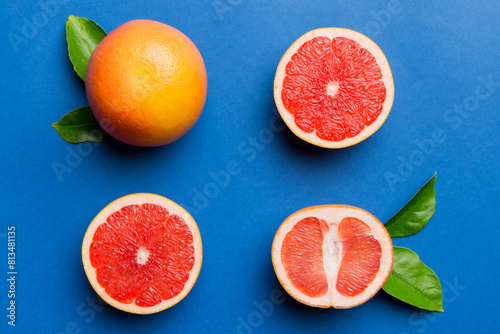 fresh Fruit grapefruit with Juicy grapefruit slices on colored background. Top view. Copy Space. creative summer concept. Half of citrus in minimal flat lay with copy space