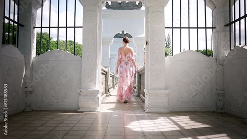 Traveller in summer dress explores Ujung Water Palace in Bali, interior shot photo