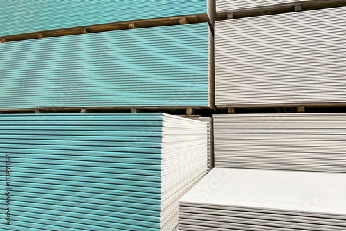 фотографія water-resistant gypsum plasterboard drywall, colored cyan, incorporates moisture additives in its core to withstand high humidity, making it ideal for use in kitchens and bathrooms