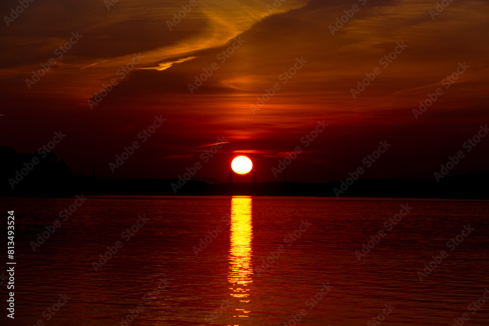 Golden sunset on the beach at neva river in saint-petersburg, russia. Tranquil scene. Nature background. Landscape. High quality photo