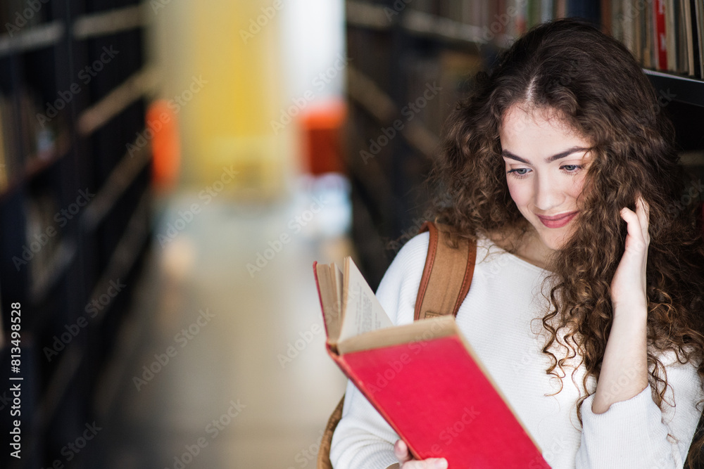 Young female student in library, focusing on final project, presentation. University student preparing for final exam. Young female student in library, focusing on final project, presentation. University student preparing for final exam.
