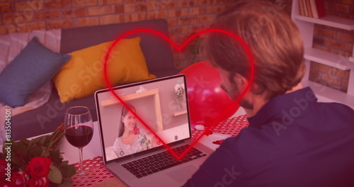 Caucasian couple enjoys virtual date; boyfriend views girlfriend on laptop