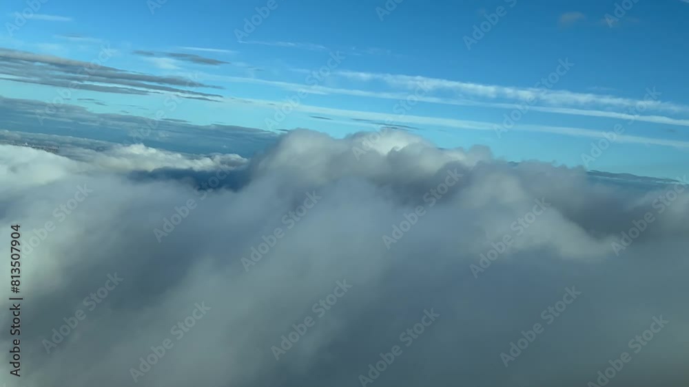 Pilot POV flying over a clouded sky shot from a jet cockpit. Daylight, blue sky. Immersive view. 4K 60FPS Pilot POV flying over a clouded sky shot from a jet cockpit. Daylight, blue sky. Immersive view. 4K 60FPS