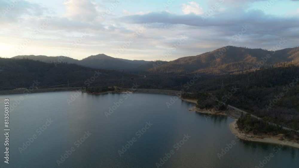 Flyover of the southern portion of Whiskeytown Lake with mountains and sunrise clouds in the background. Flyover of the southern portion of Whiskeytown Lake with mountains and sunrise clouds in the background.
