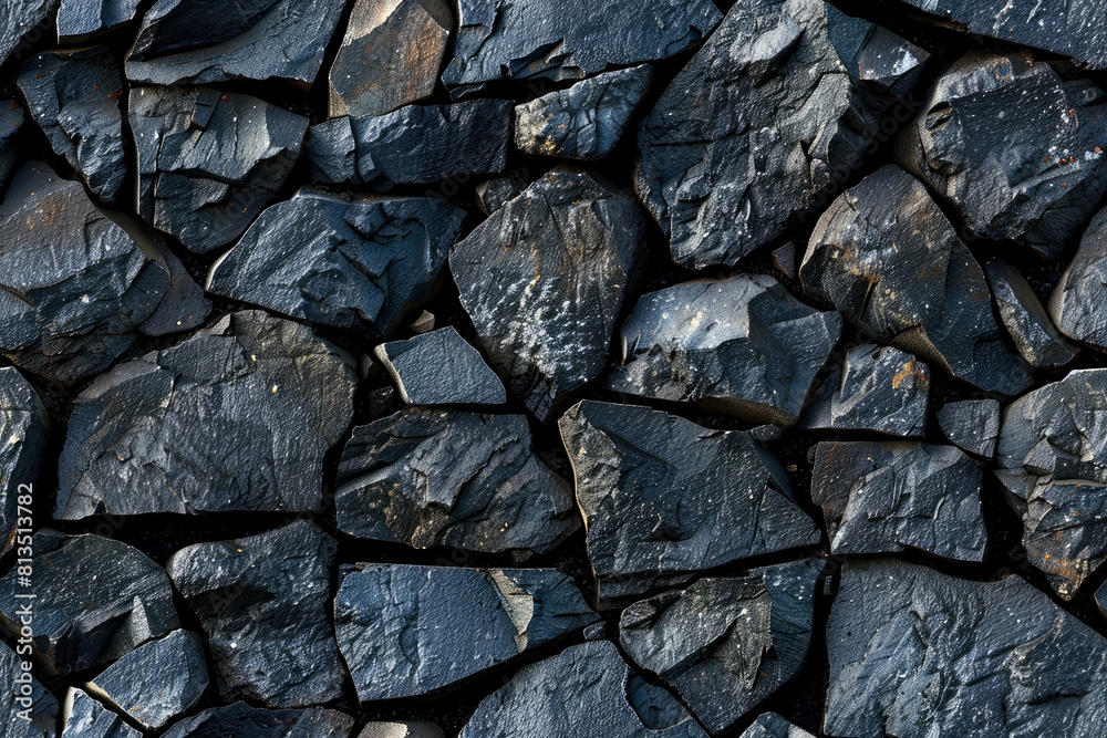 Seamless close-up of a black stone wall. Seamless detailed texture of dark jagged rocks arranged unevenly with visible natural patterns and varying shapes in daylight Seamless close-up of a black stone wall. Seamless detailed texture of dark jagged rocks arranged unevenly with visible natural patterns and varying shapes in daylight