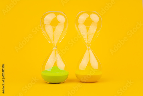 Hourglass on yellow background, time and countdown time limit for urgent work to meet deadlines and appointments.