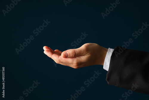 Businessman's hand close-up on a dark background