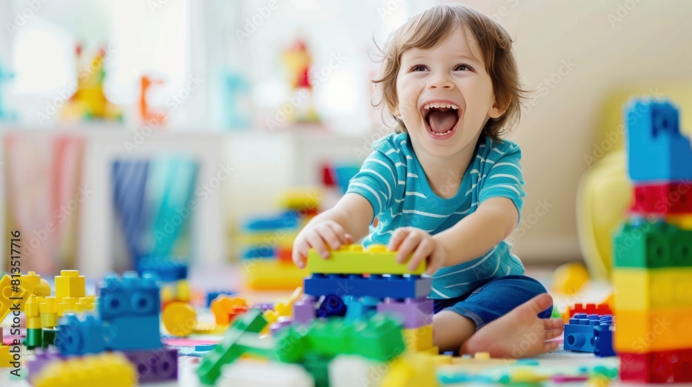 A young child is playing with a large pile of colorful A young child is playing with a large pile of colorful