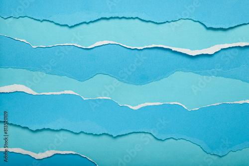 Torn blue paper strips simulating sea waves. Background, texture. photo