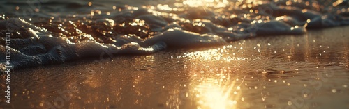 Detailed view of water gently lapping the sandy shore on a beach during sunset