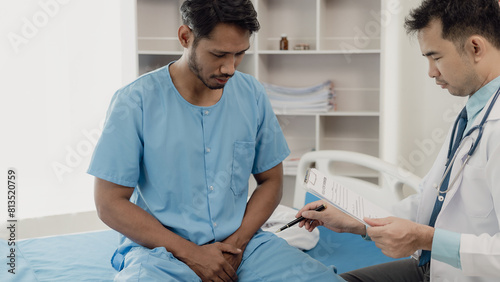 A young man consults his doctor about the idea of ​​an enlarged prostate.
At the doctor's appointment Focusing on hands and organs The scene explains the patient's cause and location of prostate disea photo