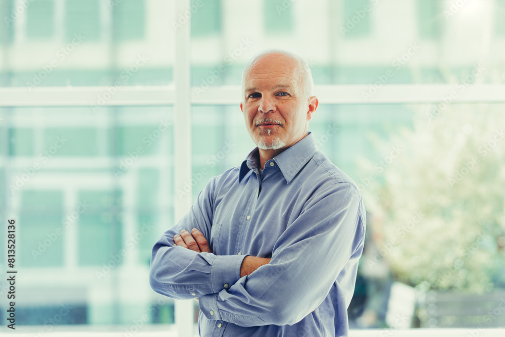 Mature man in office exudes calm professionalism Mature man in office exudes calm professionalism