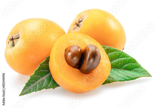 Ripe perfect loquat fruits with green leaves isolated on white background.
