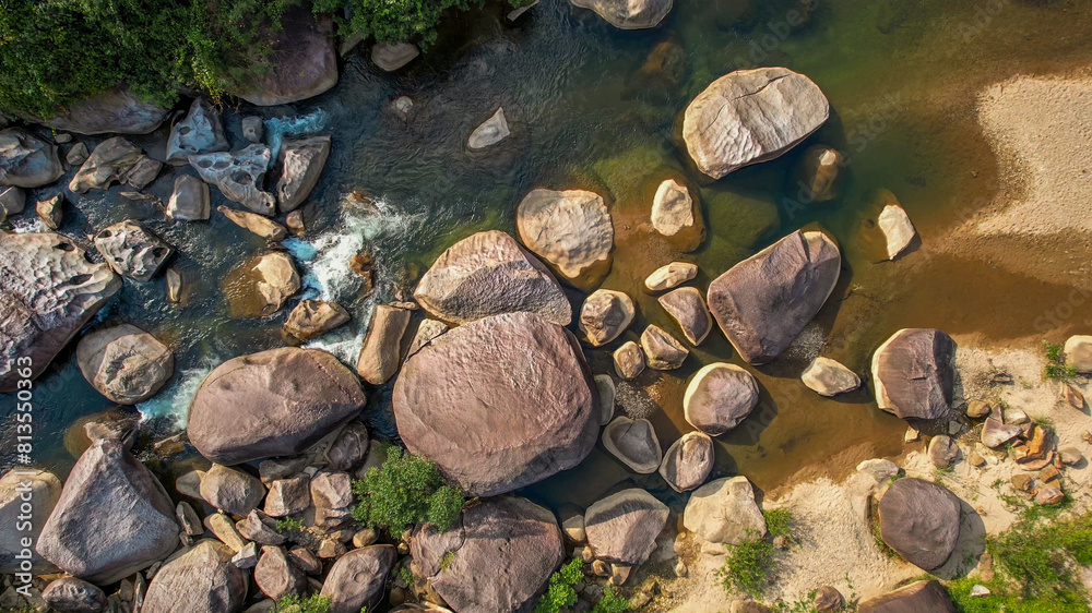 Aerial view of a serene rocky riverbed amidst lush greenery, perfect for themes of nature conservation, Earth Day, and tranquil outdoor landscapes Aerial view of a serene rocky riverbed amidst lush greenery, perfect for themes of nature conservation, Earth Day, and tranquil outdoor landscapes