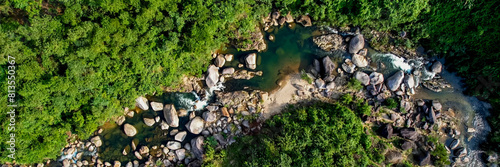 Aerial view of a serene rocky riverbed amidst lush greenery, perfect for themes of nature conservation, Earth Day, and tranquil outdoor landscapes