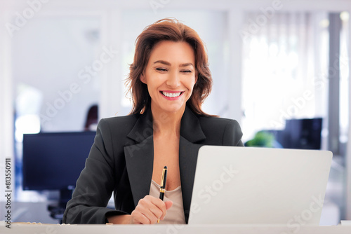 Businesswoman sitting at the office and using her laptop for work