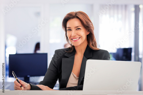 Businesswoman sitting at the office and using her laptop for work