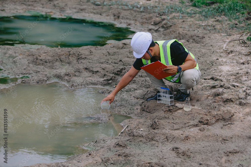Environment Issue concept. Team of Scientists in protective suits and masks took a sample of water for analysis. Environment Issue concept Environment Issue concept. Team of Scientists in protective suits and masks took a sample of water for analysis. Environment Issue concept