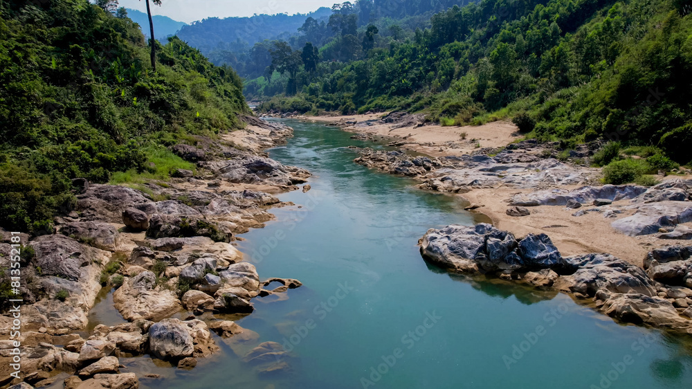 Serene river flowing through a rocky landscape with lush greenery, perfect for nature and travel themes, especially for Earth Day promotions