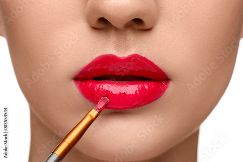 Woman applying lip gloss on white background, closeup © New Africa