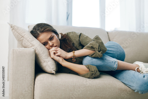 Lonely Woman Contemplating, Stressed and Depressed, Sitting on Couch, Expressing Despair, Indoor.