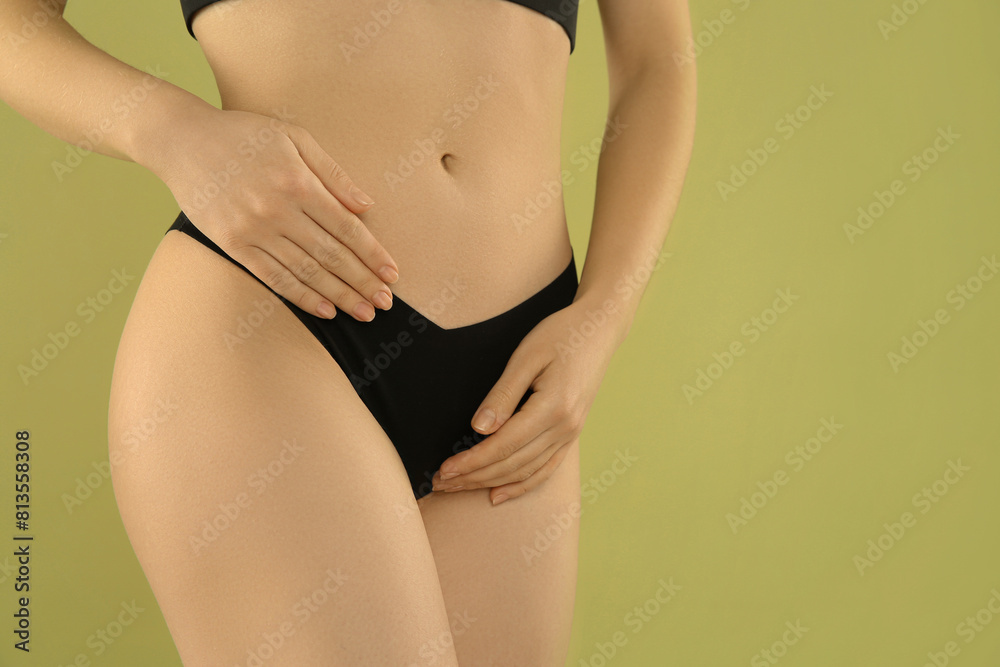 Gynecology. Woman in underwear on green background, closeup. Space for text