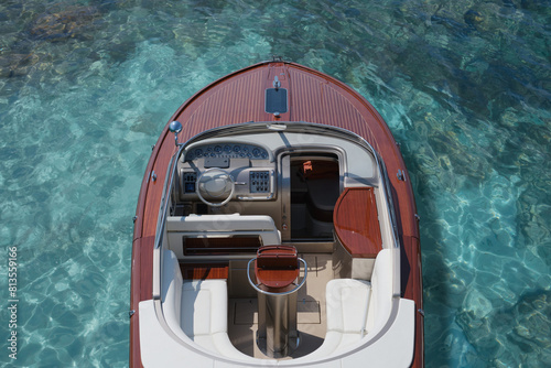 Expensive wooden boat on blue azure water, top view. Exclusive expensive boat on the clear azure water of the shore, top view. Luxurious large high-speed wooden boat on clear blue water top view.