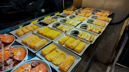 Assorted asian dishes on display at a night market stall, related to Asian cuisine and Lunar New Year celebrations