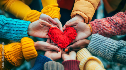 Hands holding heart. United diversity or multi-cultural partnership in a group	