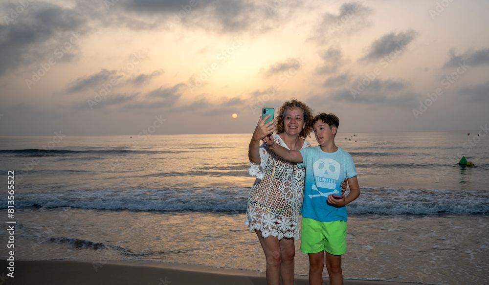 Mother and Son Taking a Selfie at Sunrise on Playa Carabassi, Elche Mother and Son Taking a Selfie at Sunrise on Playa Carabassi, Elche