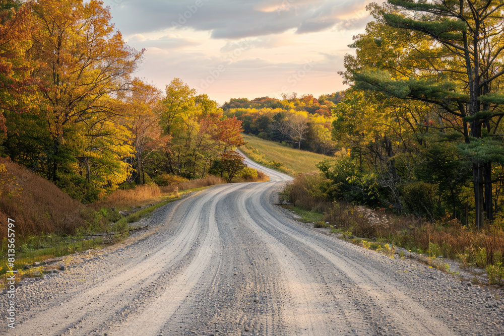 The warm glow of golden hour illuminating a winding rural road lined with trees. The minimalist composition, with just the road and colorful sky, conveys a sense of journey and adventure The warm glow of golden hour illuminating a winding rural road lined with trees. The minimalist composition, with just the road and colorful sky, conveys a sense of journey and adventure