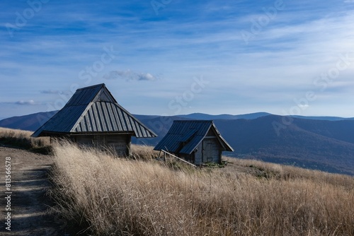 Wooden barn with Bieszczady Mountains in the back captured during daylight © Wirestock