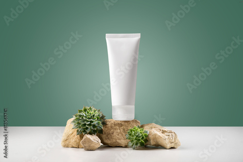 Fragile hands white mockup tube of facial cream with green plant