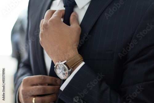 businessman adjusting their tie fashion style