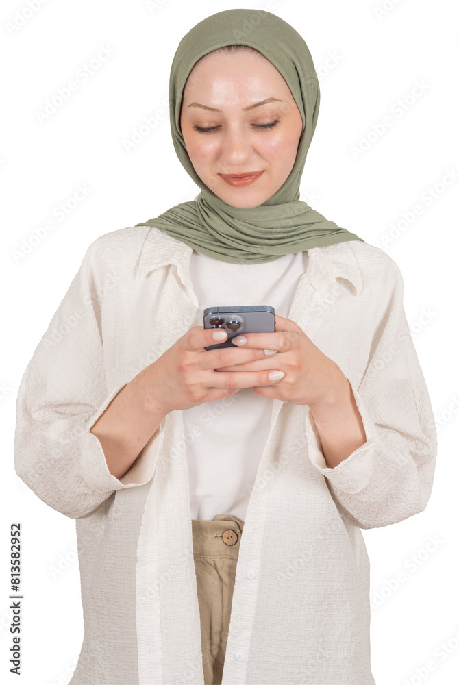 Muslim girl in hijab using smartphone, studio portrait of young beautiful muslim girl in hijab using smartphone with cool application. Smiling, positive texting or browsing social media, copy space.