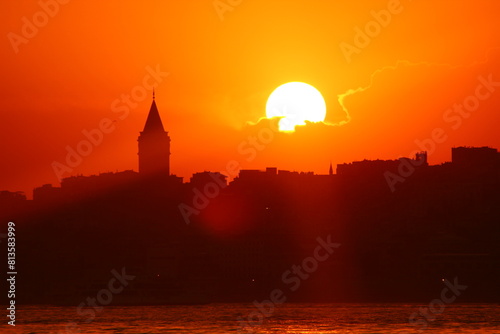 Galata Tower view at sunset with sun behind the clouds