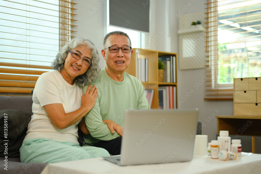 Cheerful senior couple in video conferencing with general practitioner on laptop. Telehealth concept Cheerful senior couple in video conferencing with general practitioner on laptop. Telehealth concept